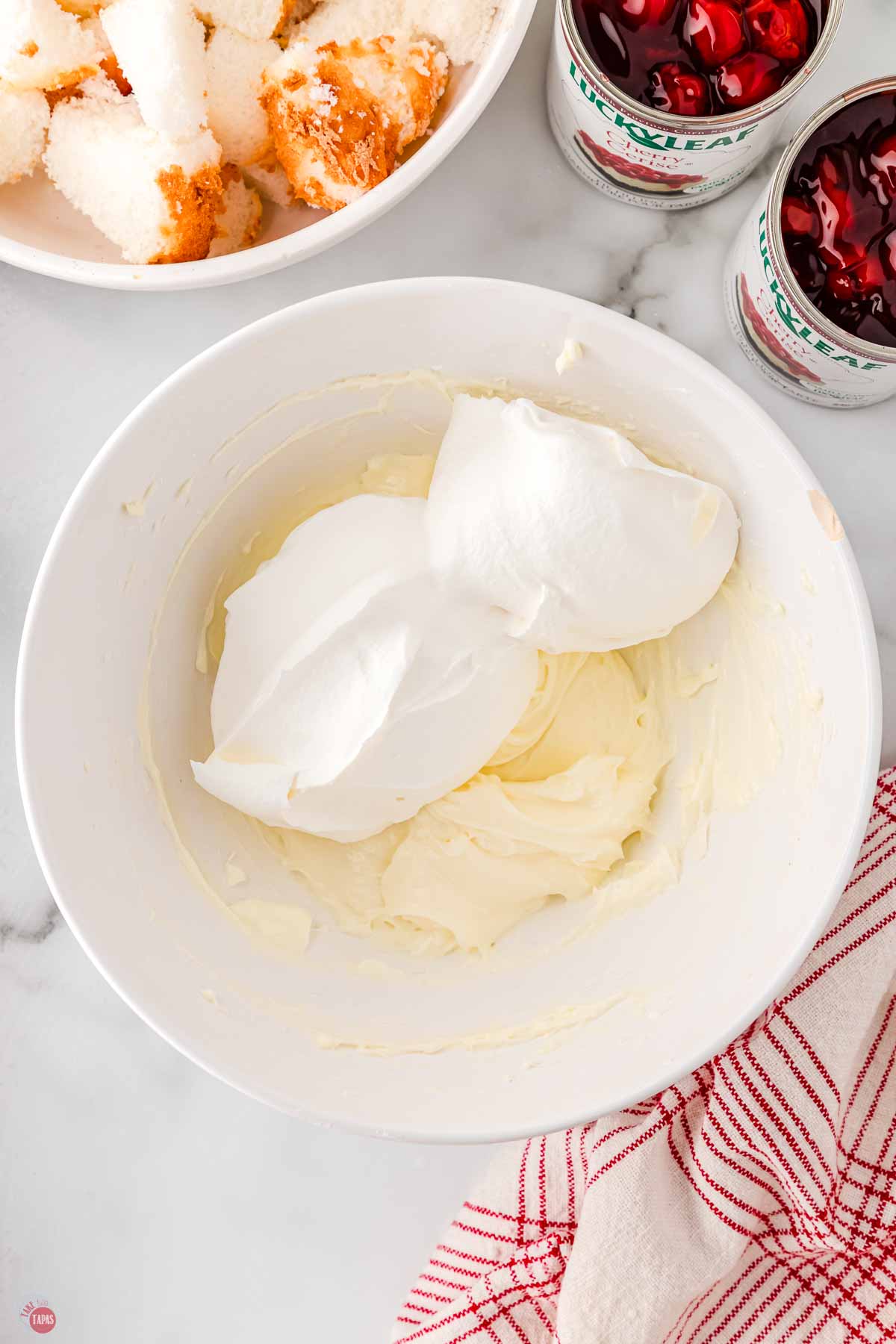 cream cheese and whipped topping in a white bowl