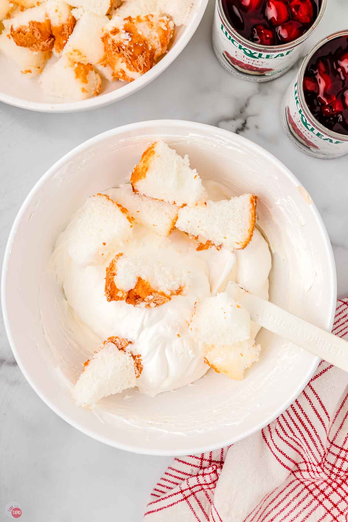 bowl of cheesecake mixture with cubes of angel food cake