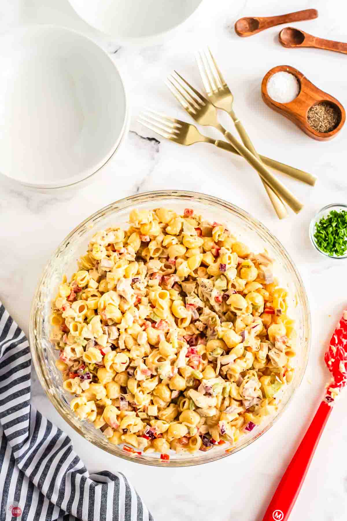 Delicious pasta salad with cheese, chicken, and vegetables, perfect for sharing.