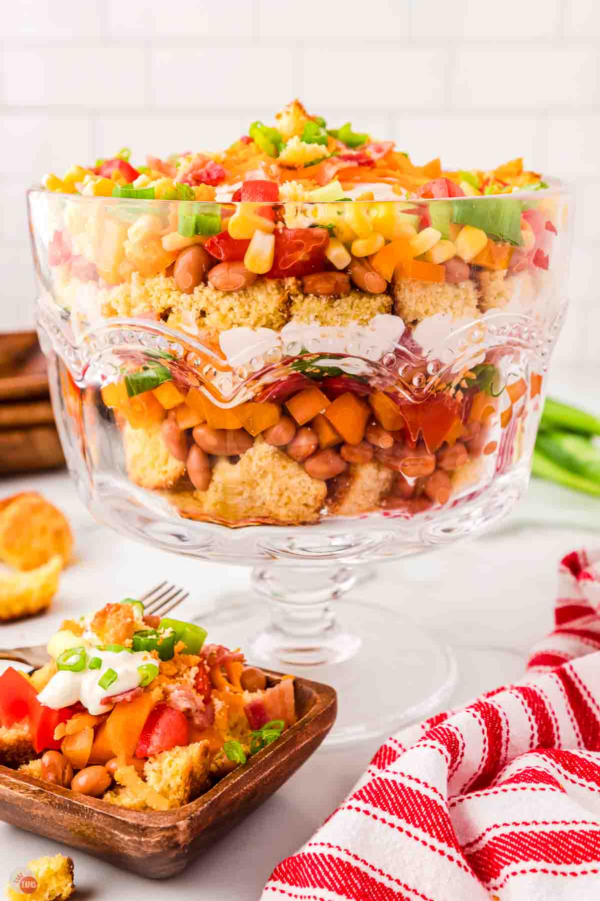 large trifle bowl with a layered salad