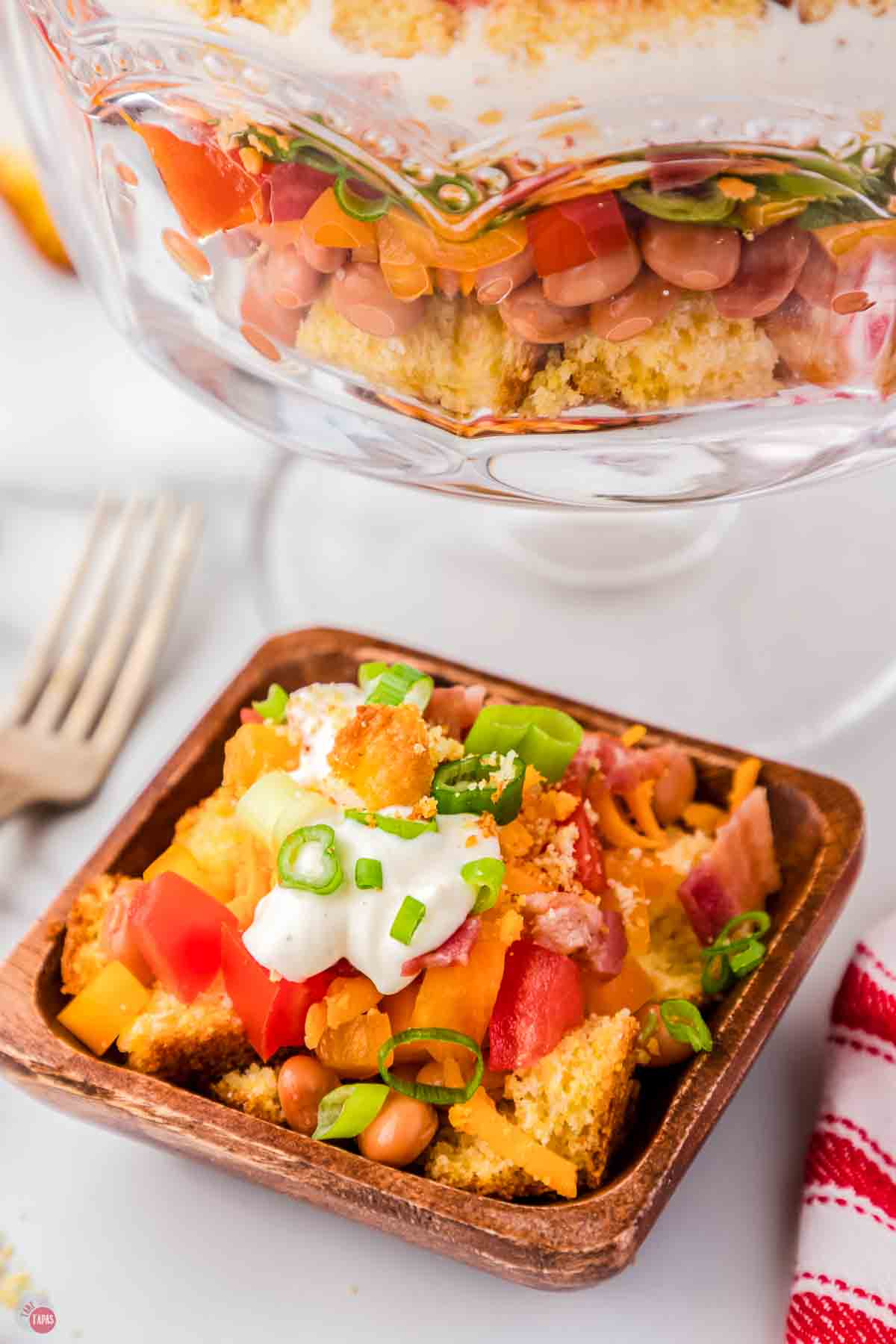 small wood bowl with salad and cornbread