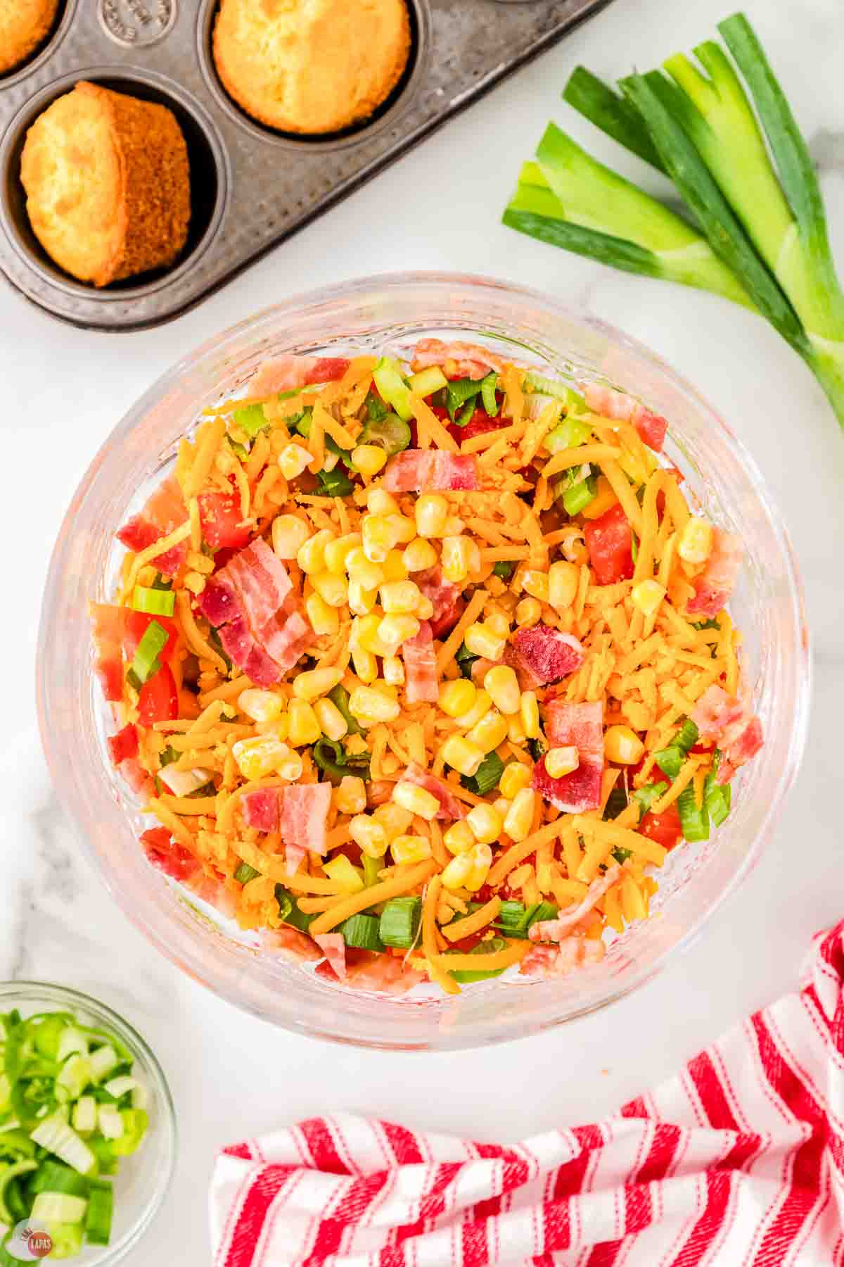 inside of a clear trifle bowl with mixed vegetables in it