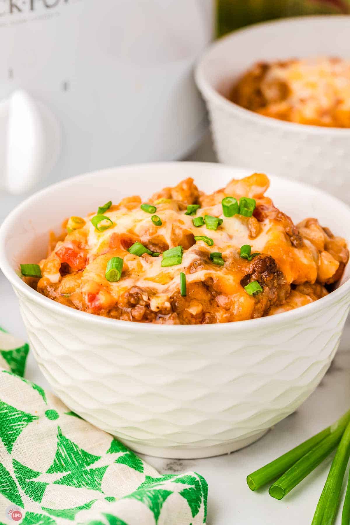 small white bowl filled with taco casserole and topped with chopped cilantro