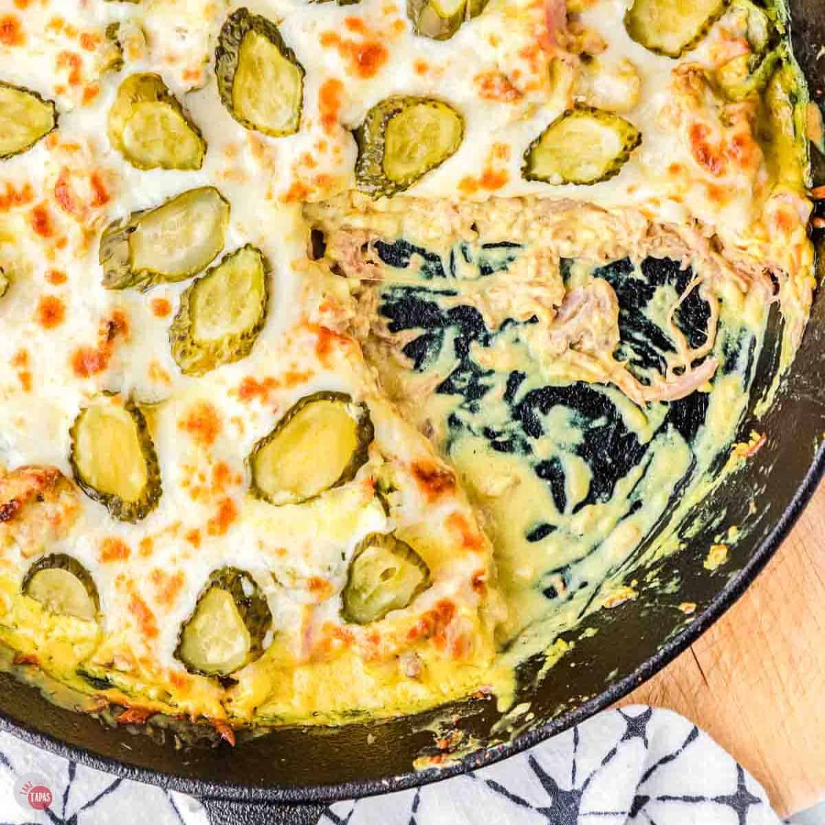 Cuban casserole in a skillet with a wedge removed
