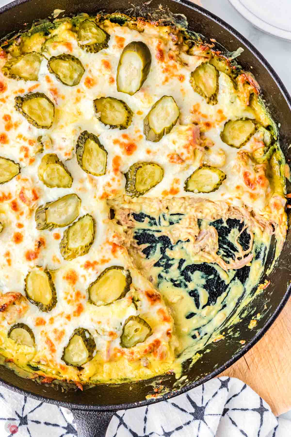 close up of pan with a casserole and a portion scooped out