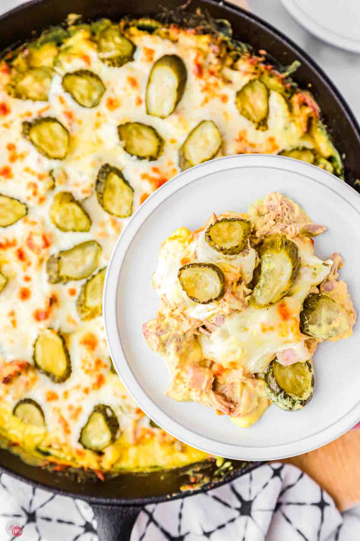 white plate with pickles and cheese on it