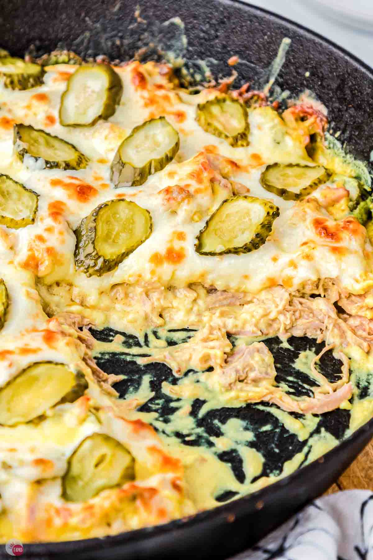 side view of a casserole in a skillet with some missing