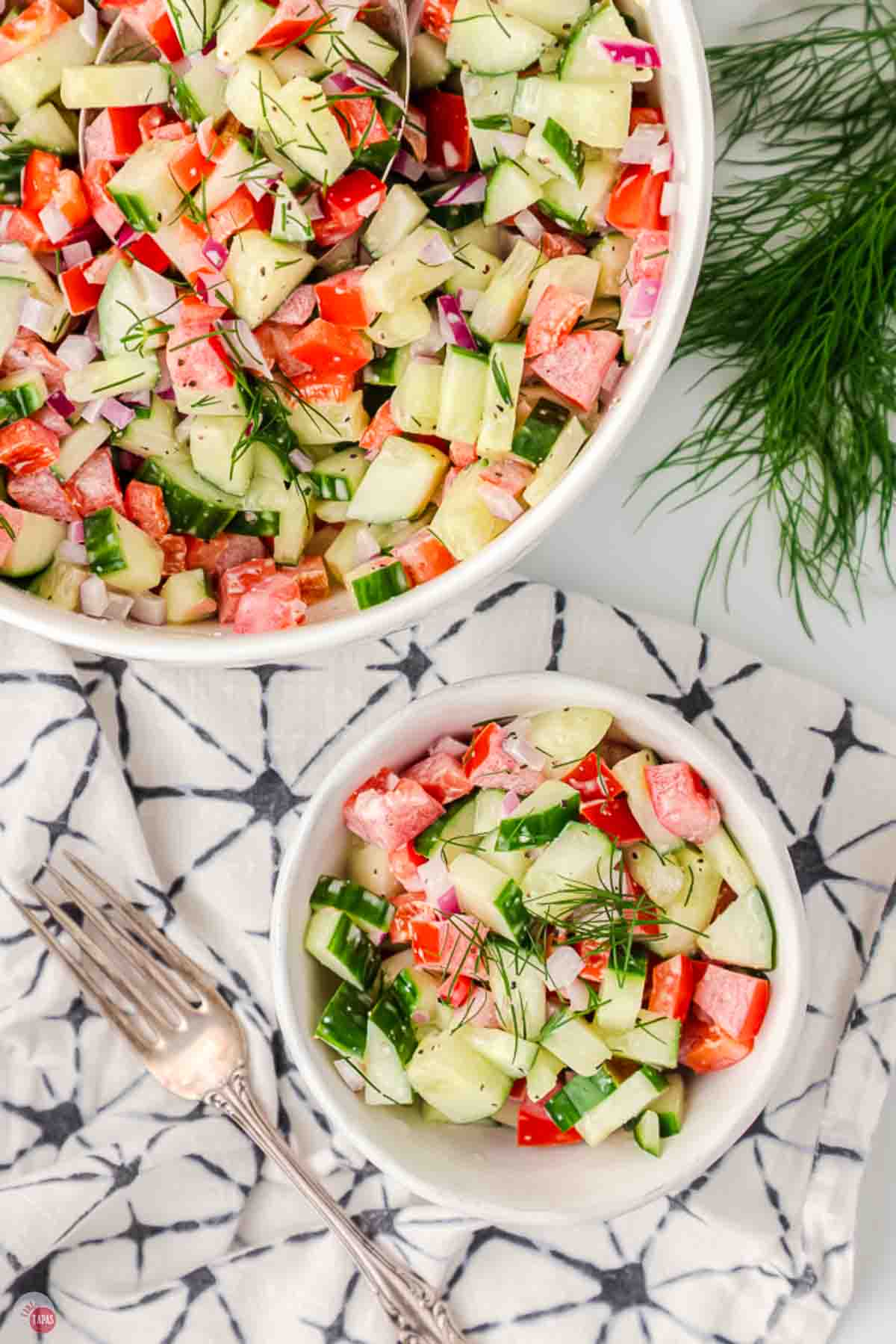 two bowls of salad on a napkin