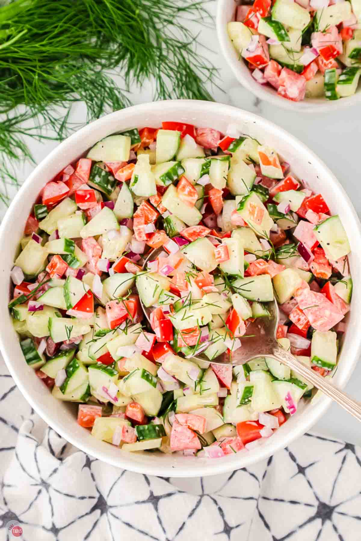 bowl of chopped tomatoes and cucumbers in a creamy dressing