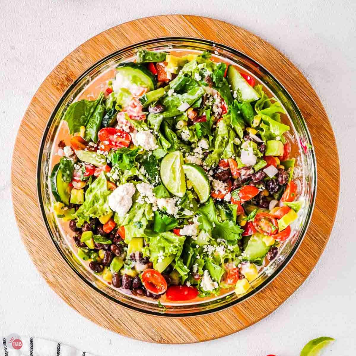 bowl of fiesta salad on a wood circle
