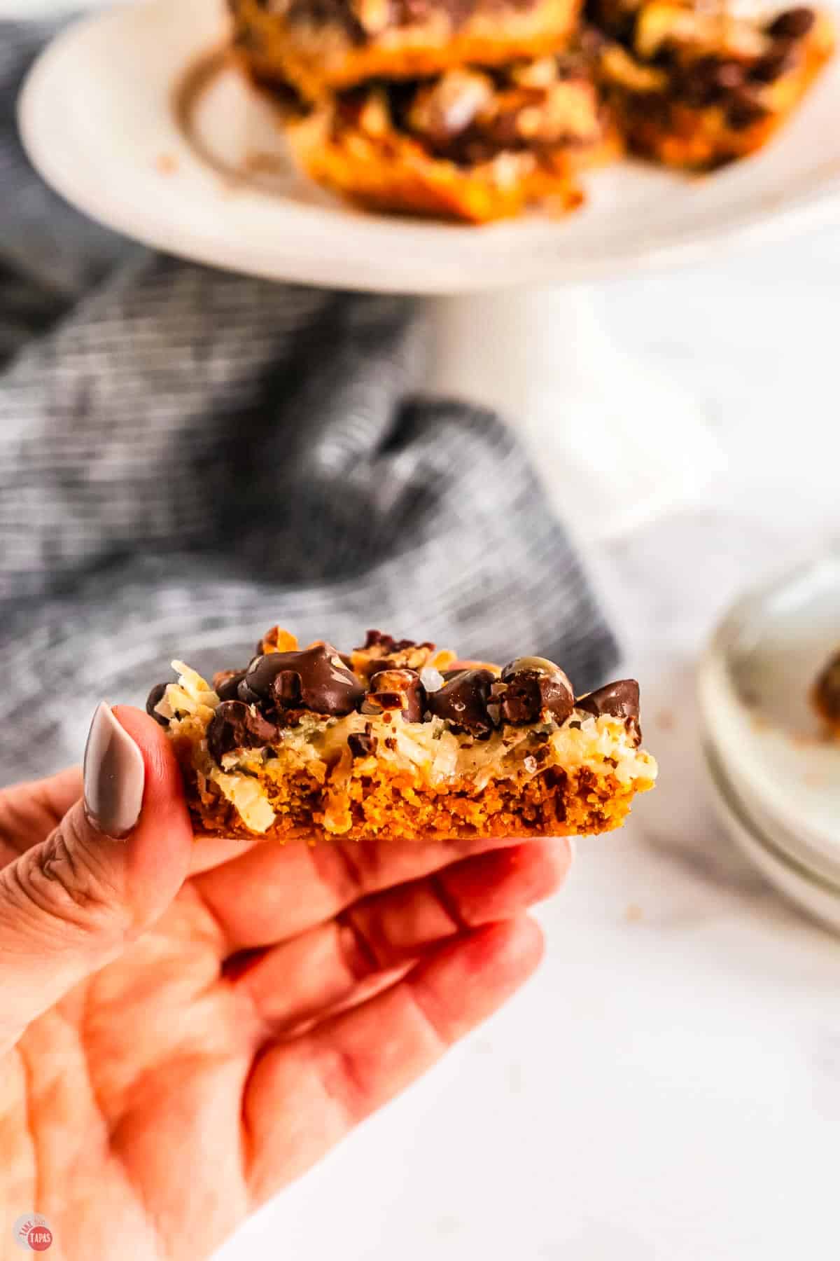 hand holding a 7 layer bar with a bite missing