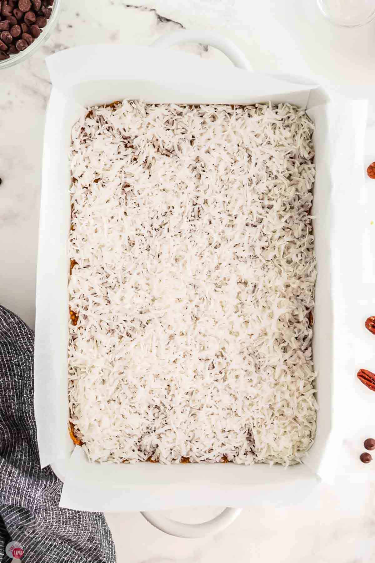 baking dish with a layer of shredded coconut