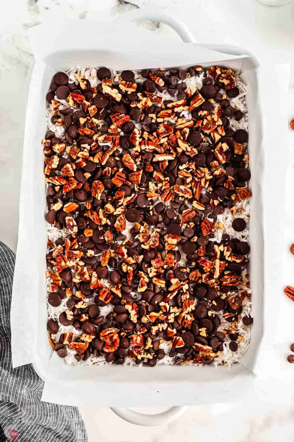 baking dish filled with chocolate chips and toasted pecans