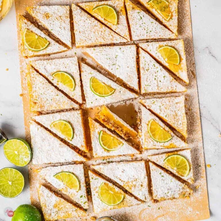 wood board with sliced margarita bars topped with lime slices