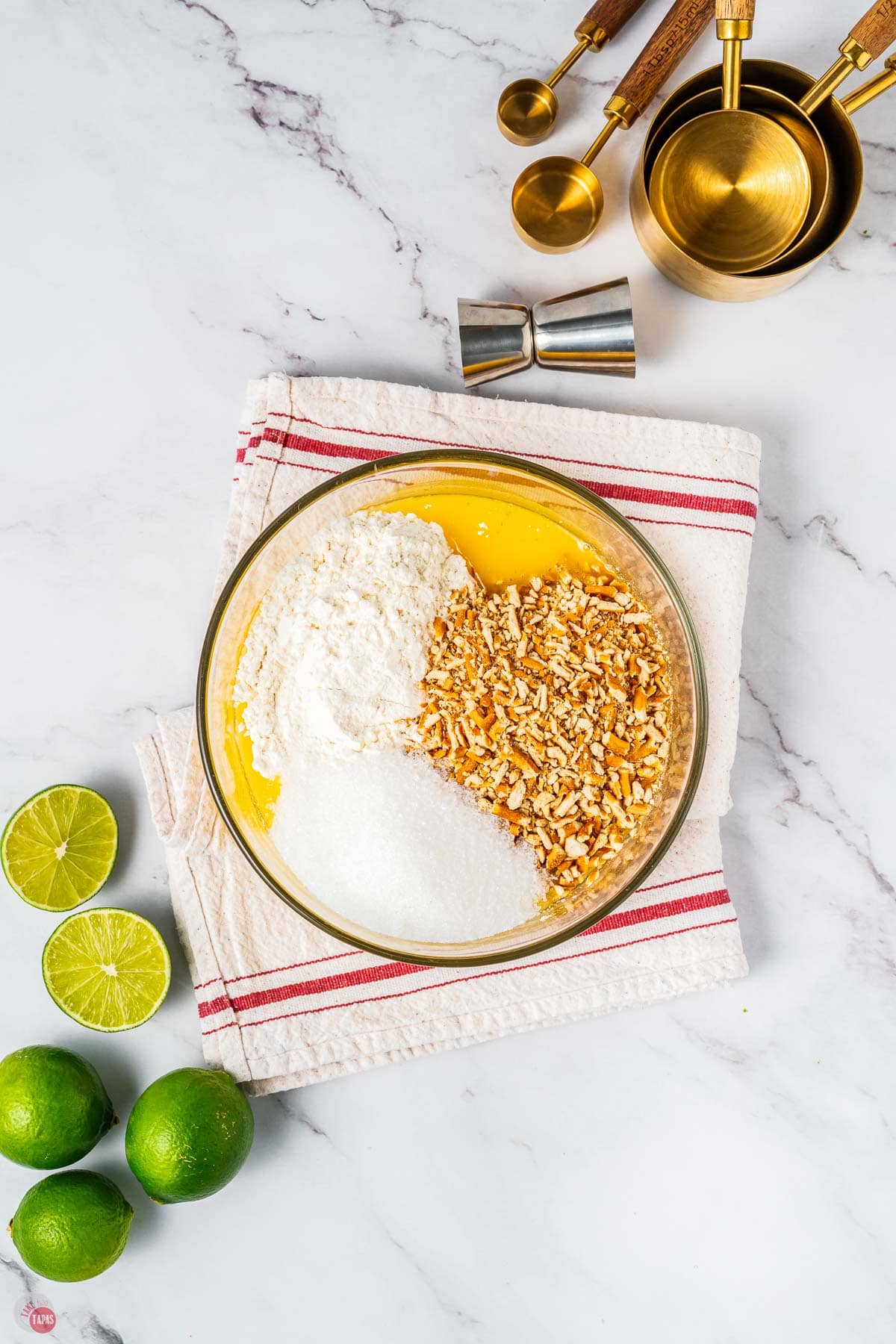 clear bowl of melted butter, crushed pretzels, and sugar