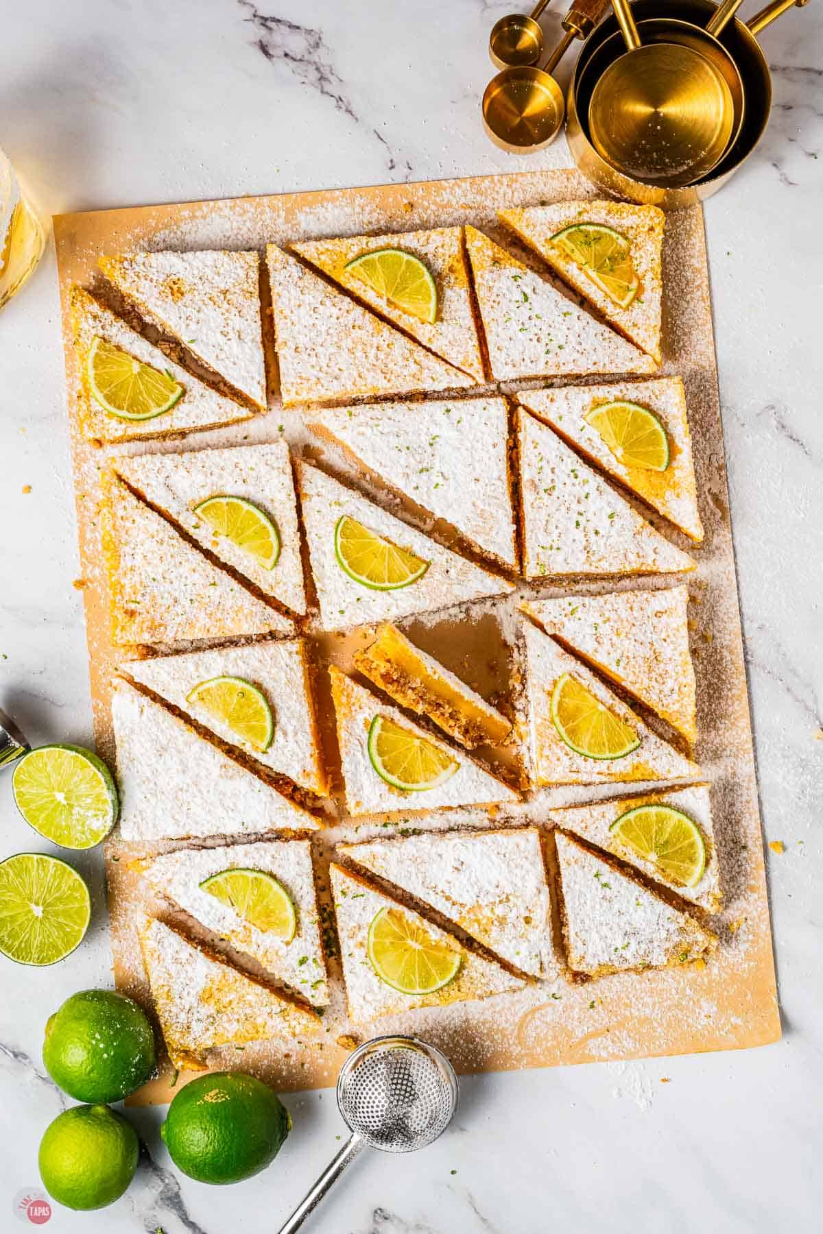 wood board with lime bars on top dusted with powdered sugar