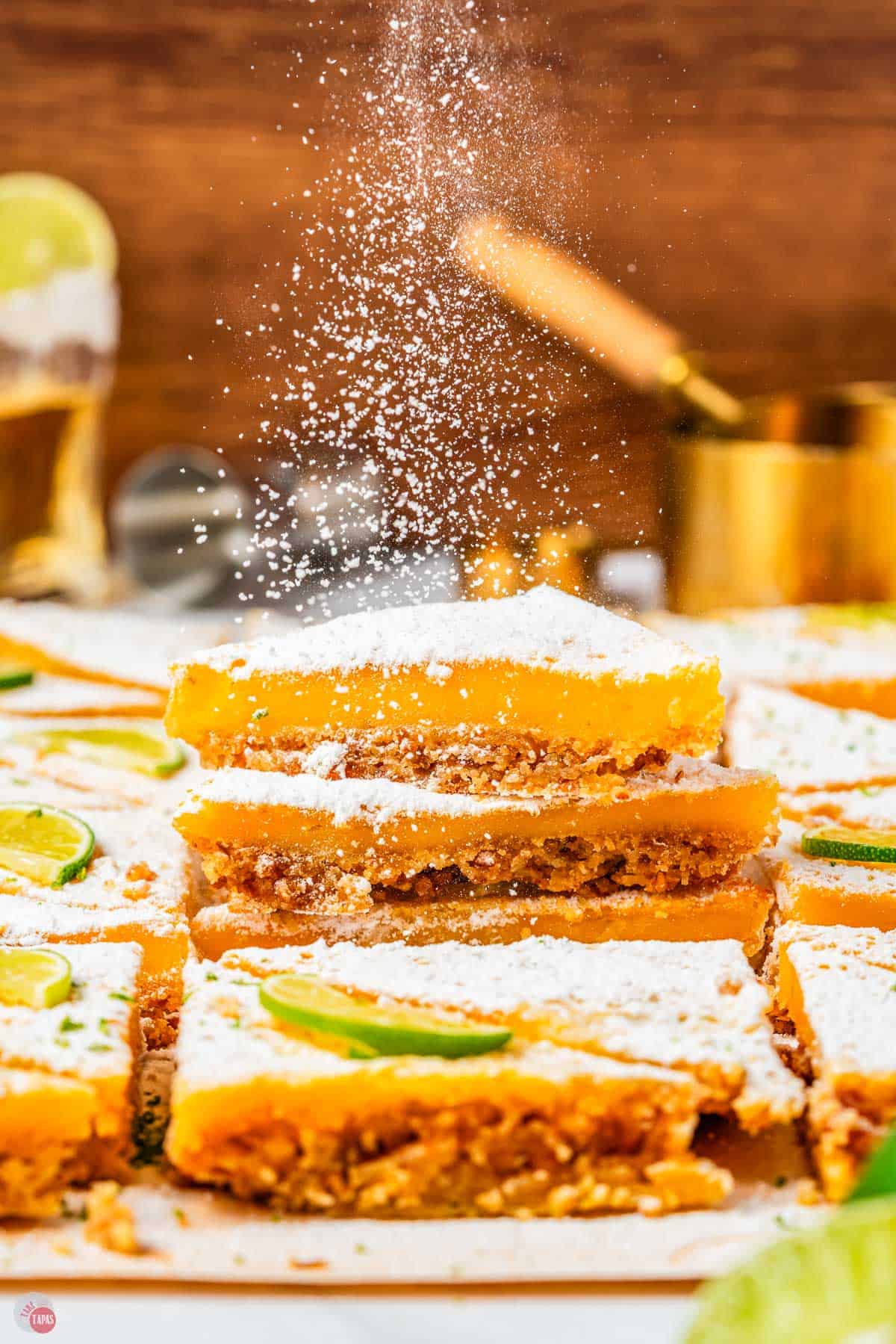 stack of margarita bars with powdered sugar being sprinkled on top