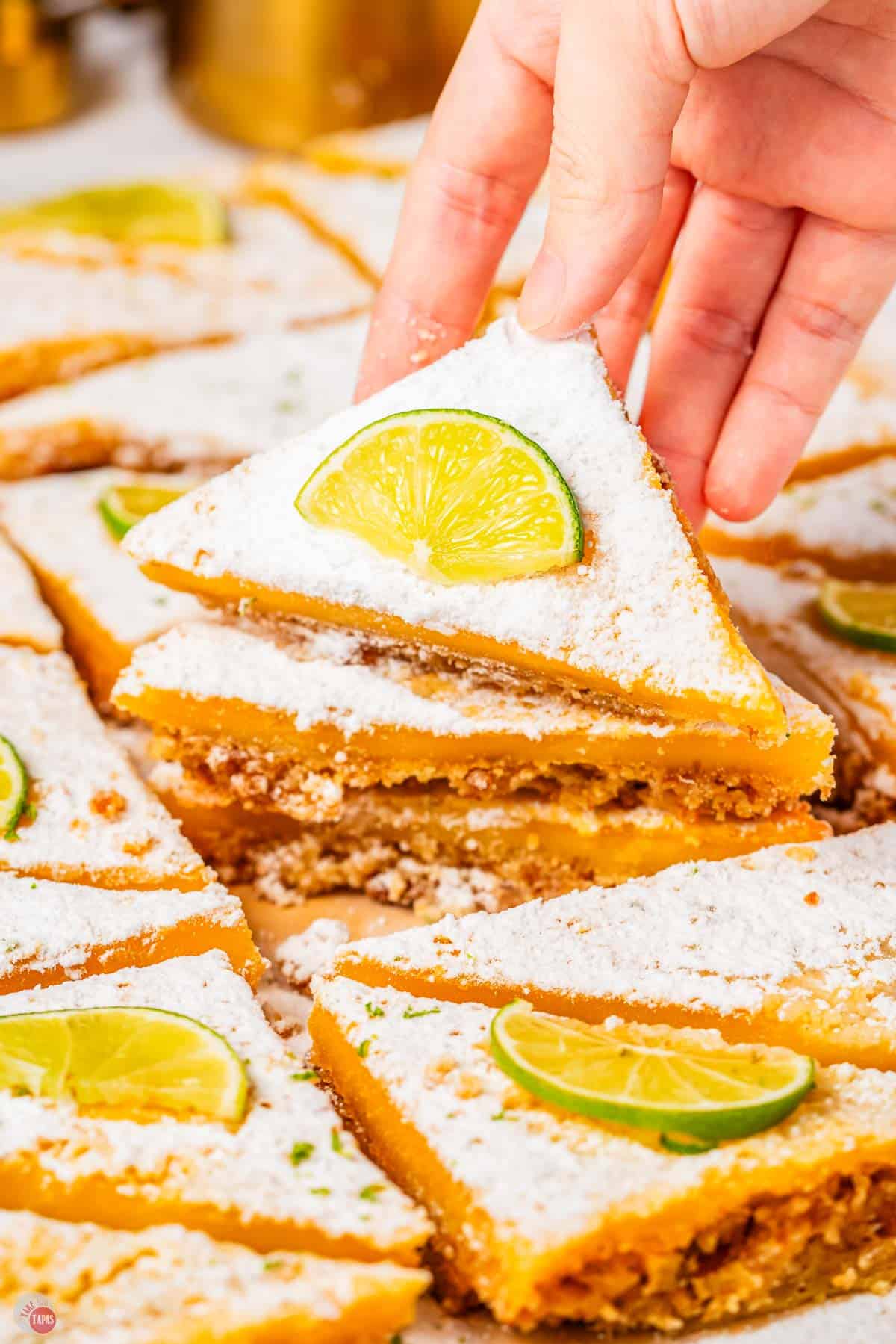 hand holding a margarita bar on top of a stack of them