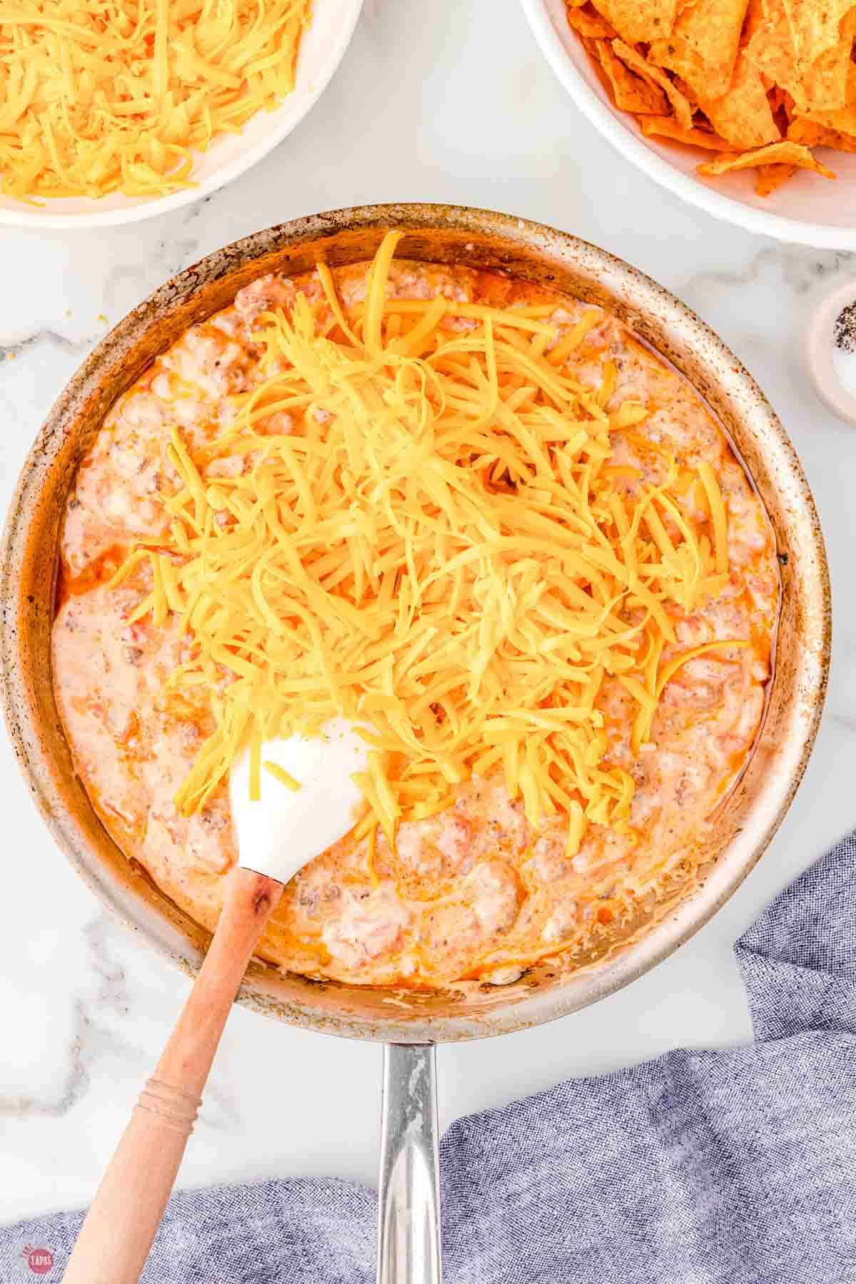 skillet with a creamy sauce and shredded cheese on top