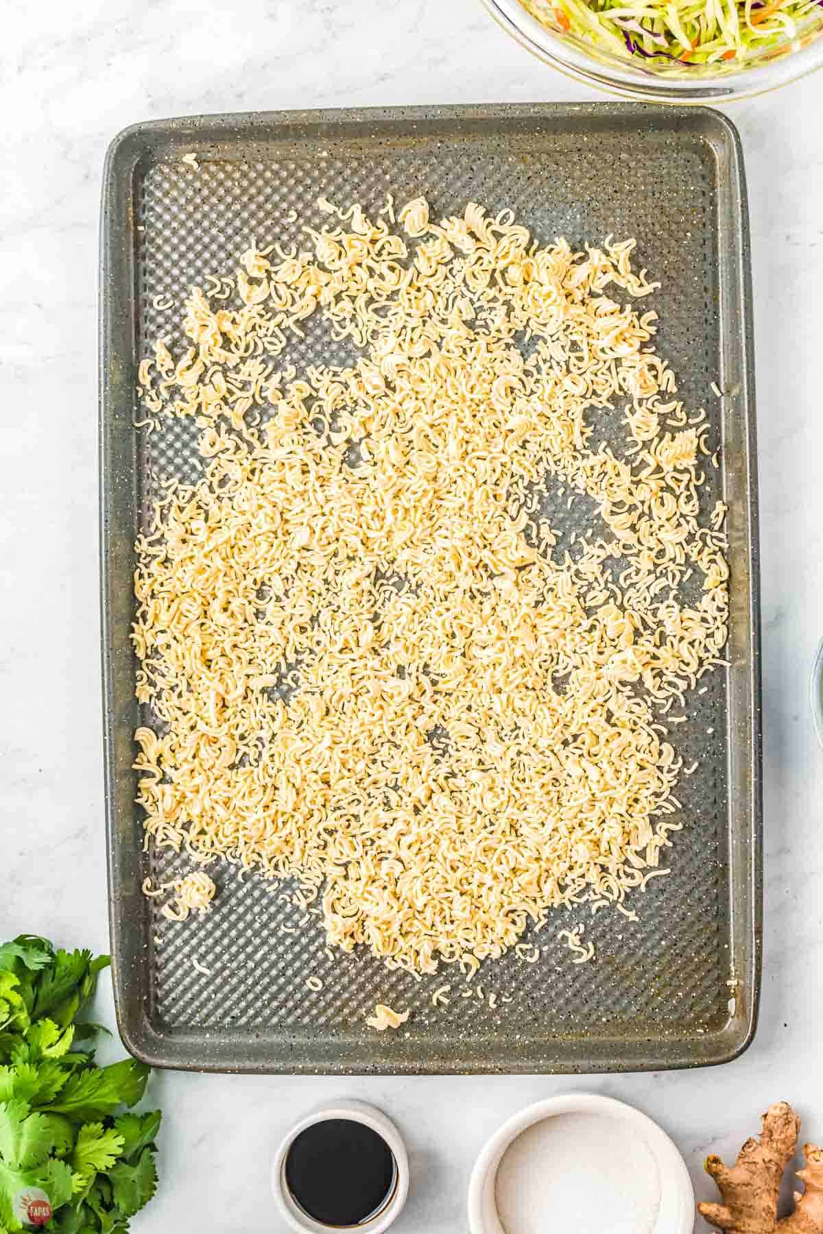 toasted ramen noodles on a baking sheet