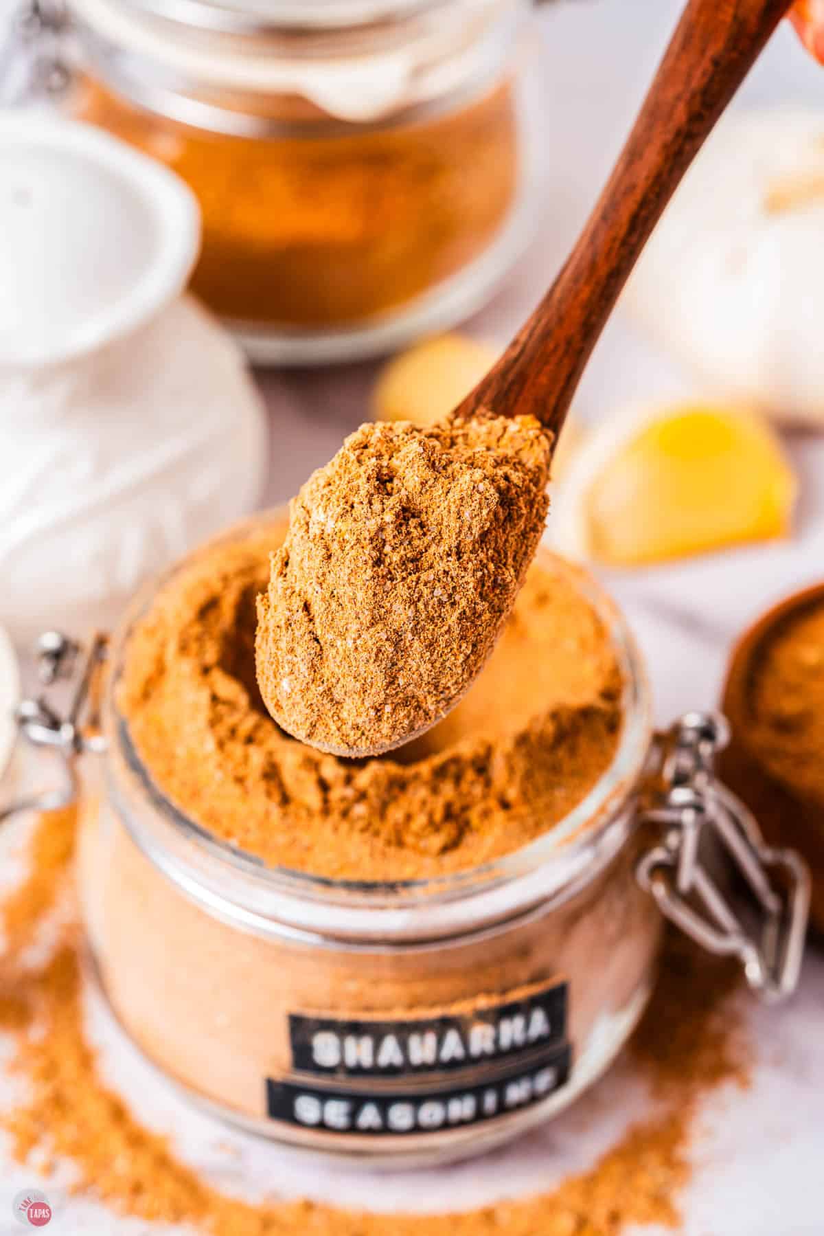small jar of spices with a spoon scooping some out