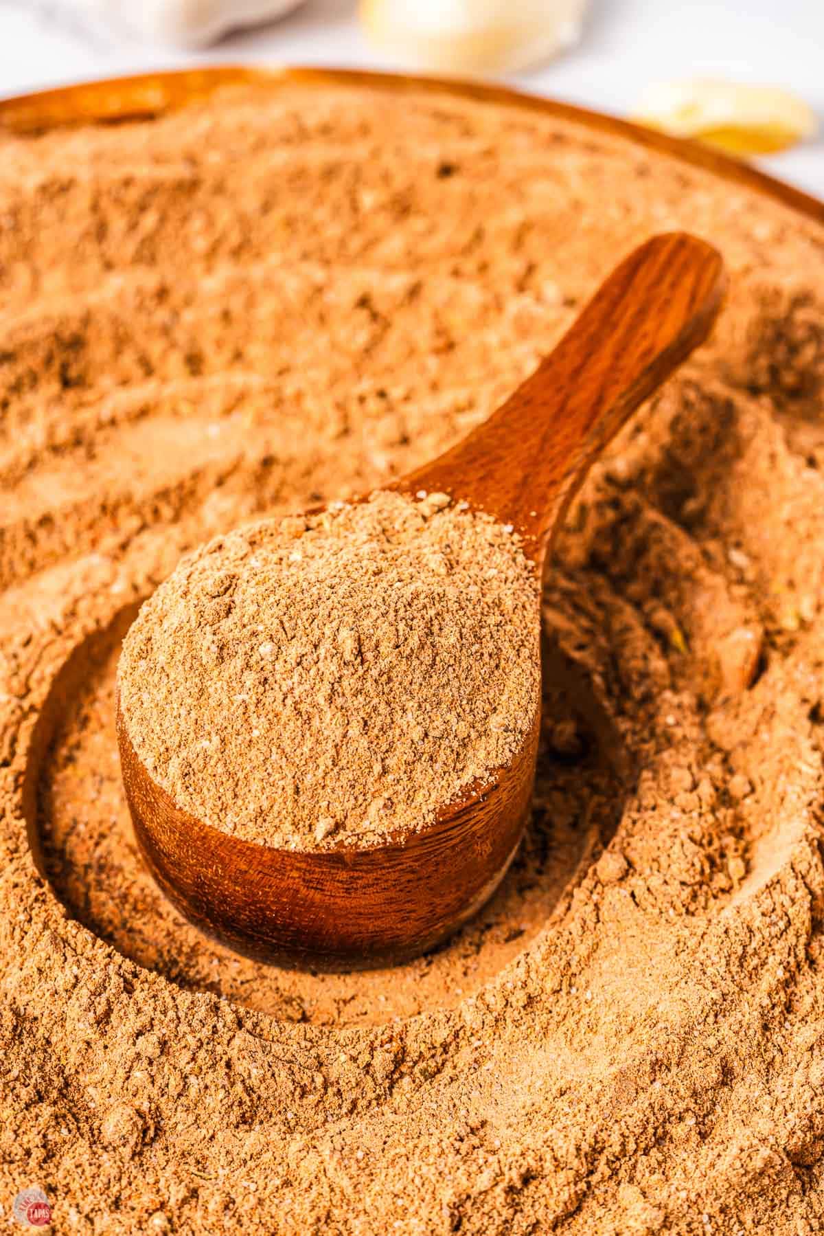 spices in a swirl with a wood spoon in the middle
