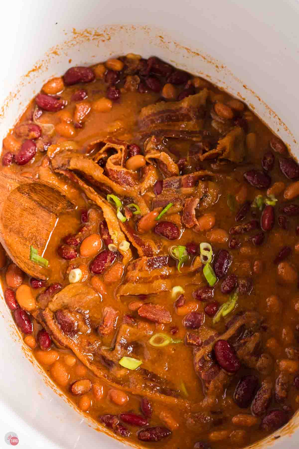 close up of white slow cooker with bbq beans
