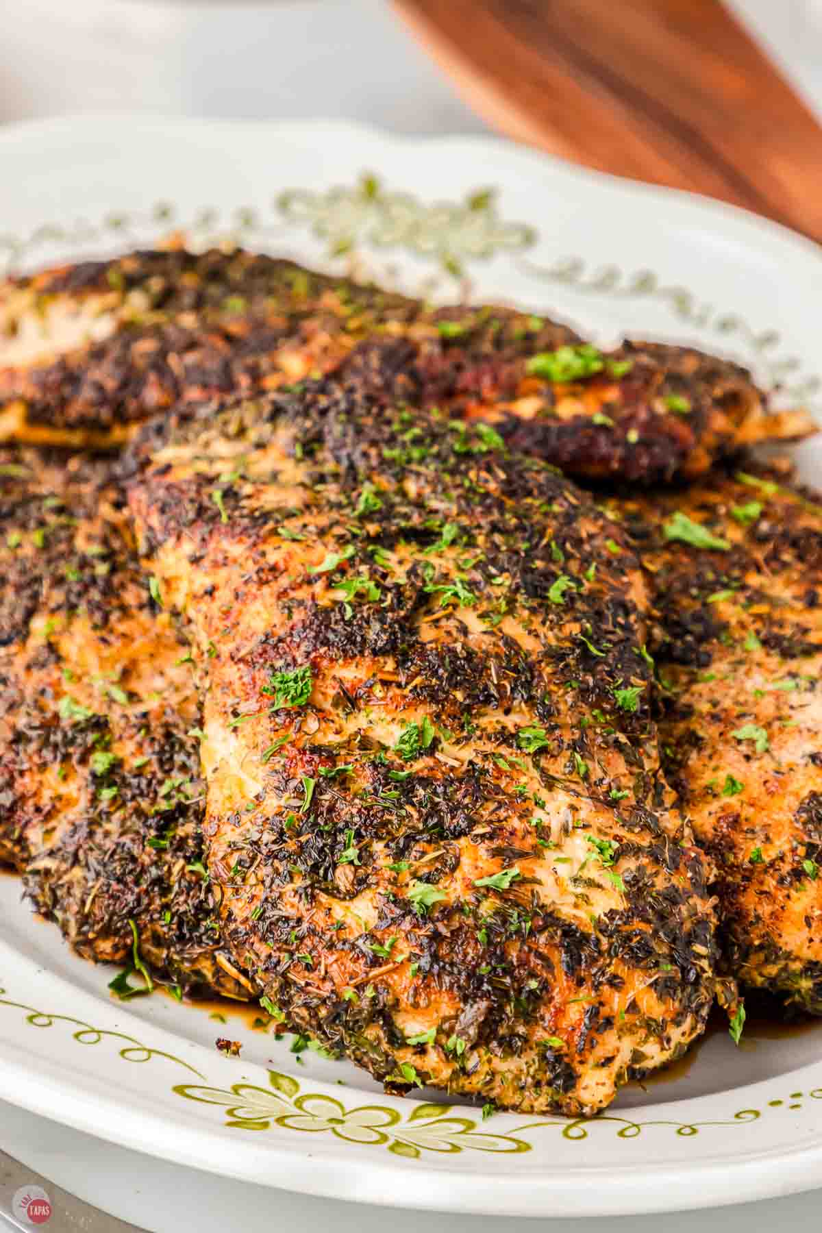 close up of herb chicken breasts on a plate