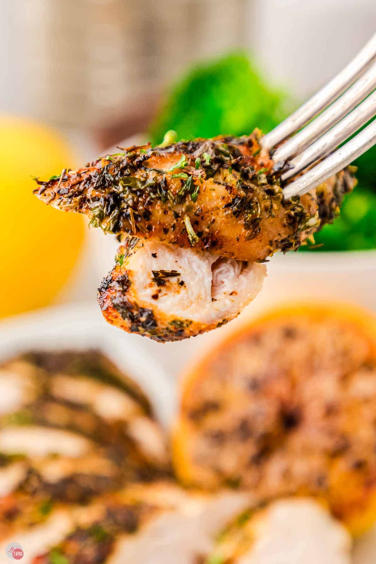 close up of two slices of chicken on a fork