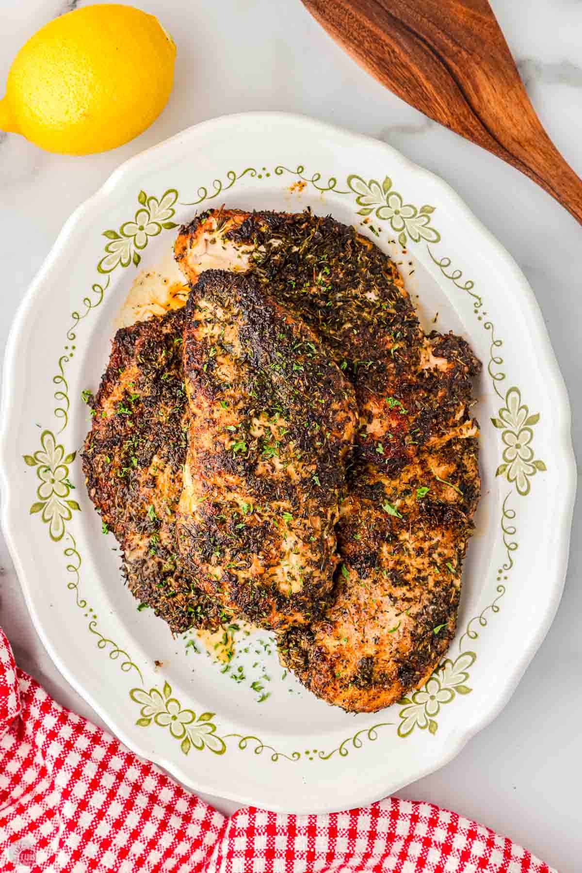 platter with cooked chicken breasts on it