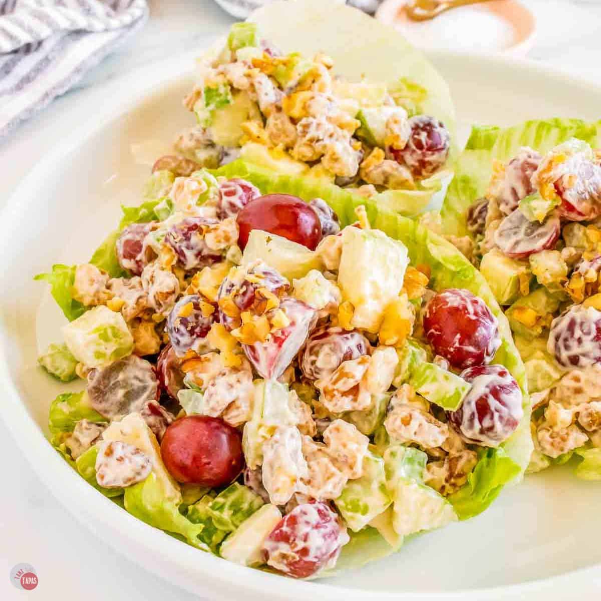 three lettuce cups with creamy chopped fruit and nuts