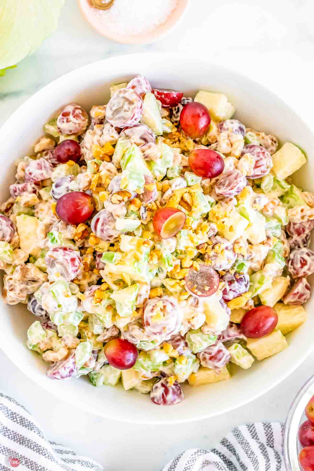 close up of waldorf salad with  grapes and walnuts