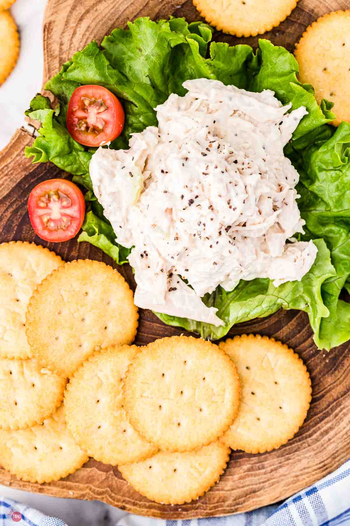 scoop of chicken salad on a lettuce leaf with crackers