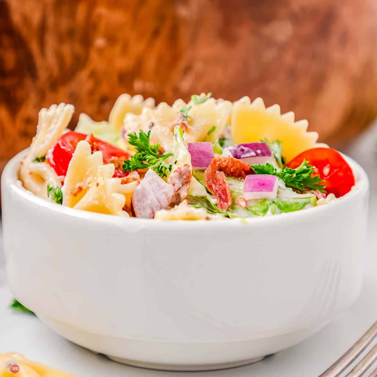 blt pasta salad in a white bowl
