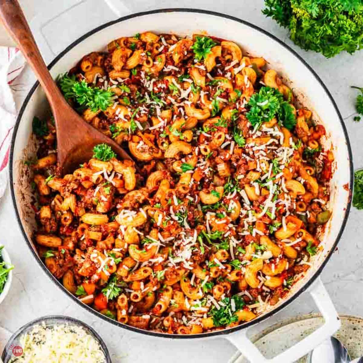 white pot with beefaroni and a wood spoon