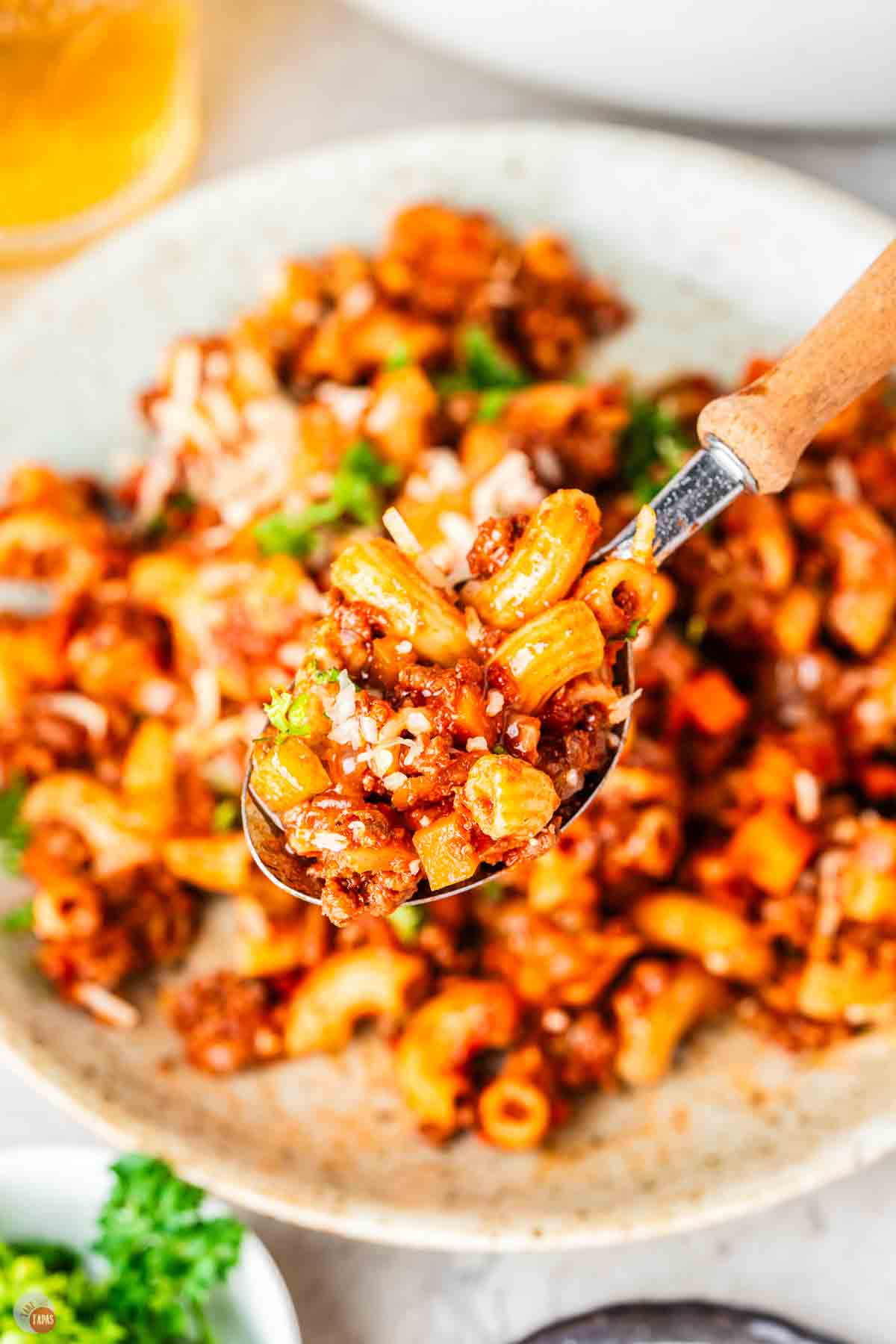 close up of spoon with pasta and meat sauce