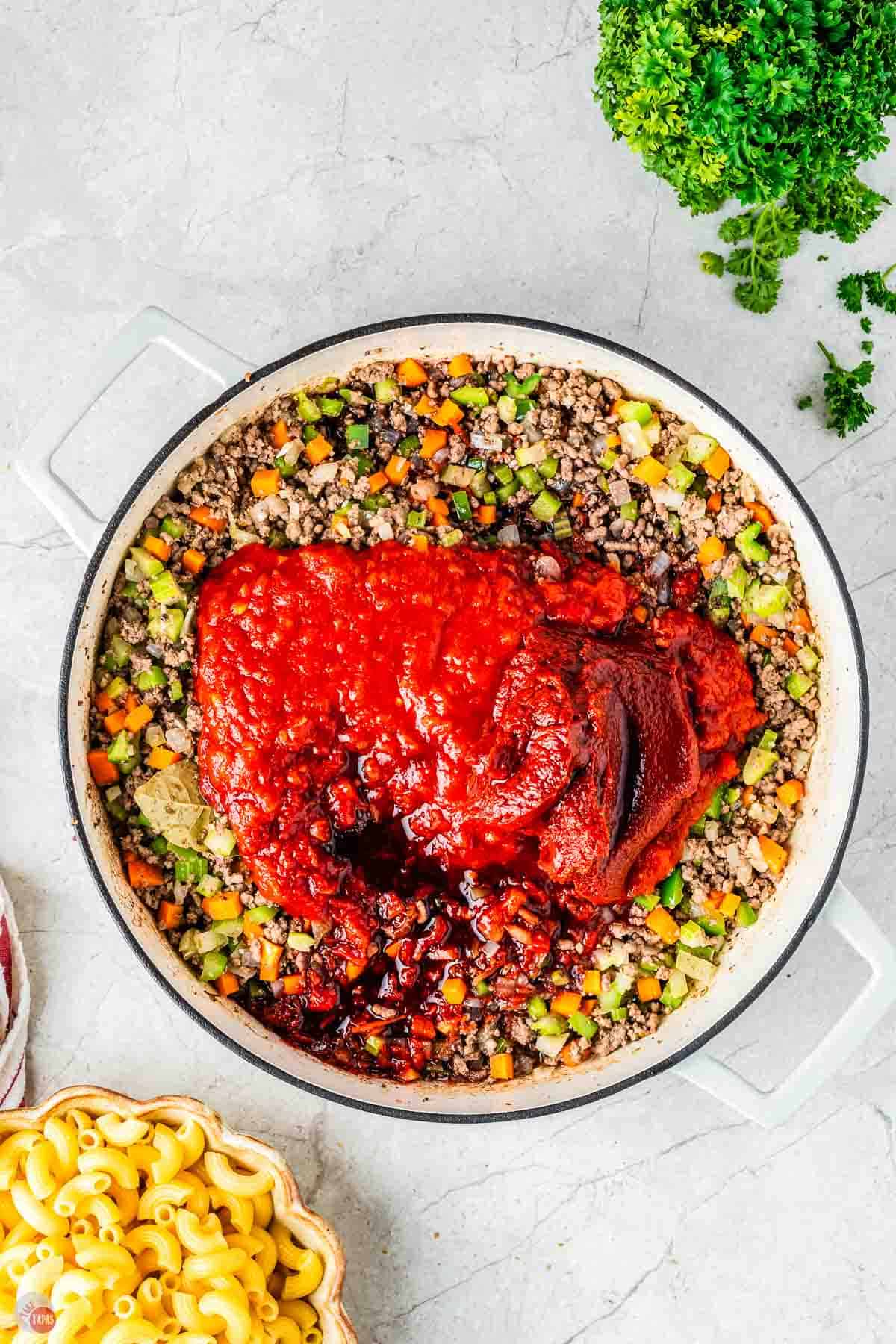ground beef and vegetables with two piles of tomatoes on top
