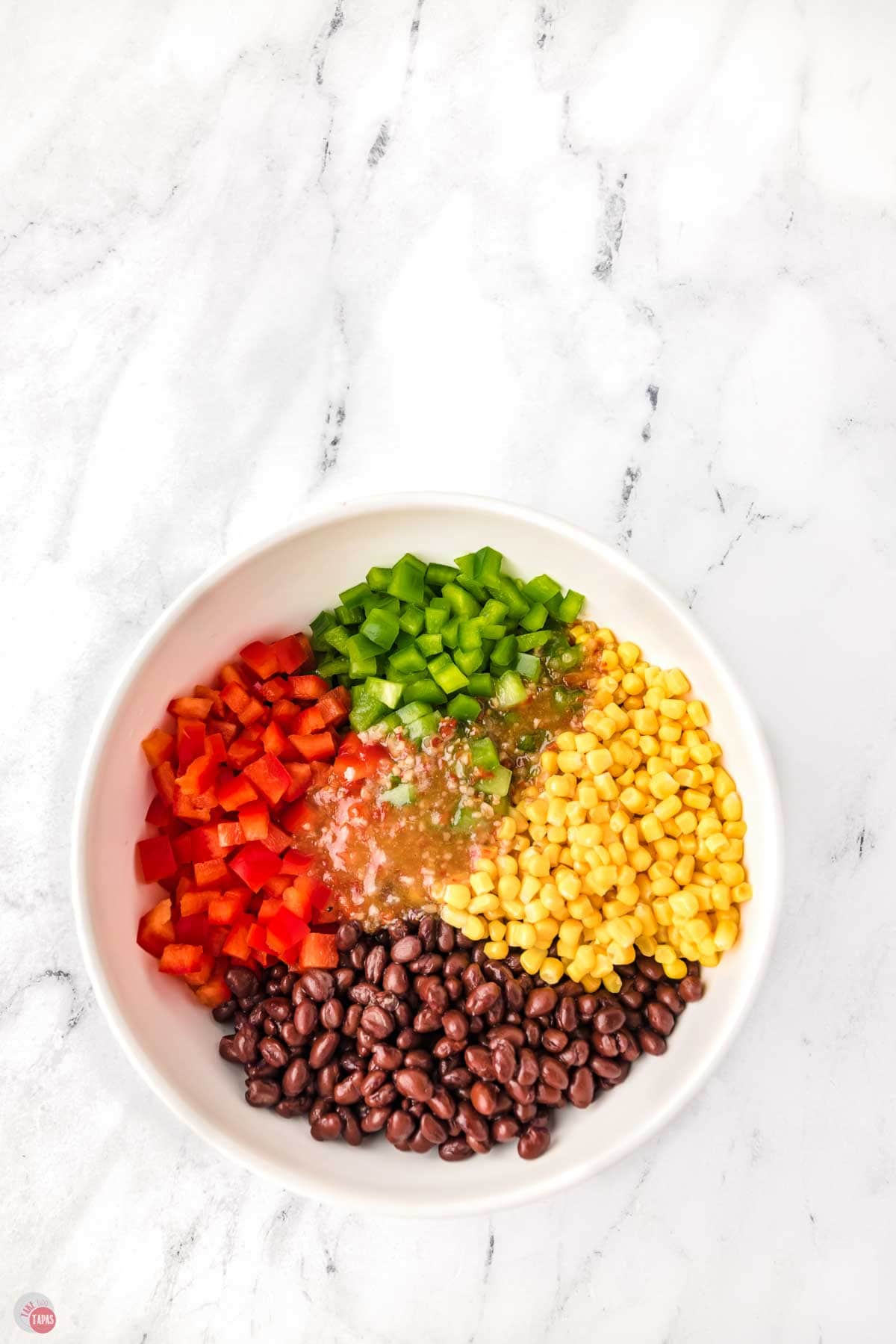 white bowl with segments of different fresh vegetables