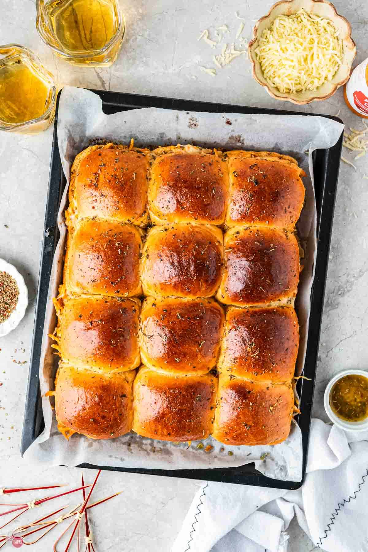 baked buffalo chicken sliders on a baking tray