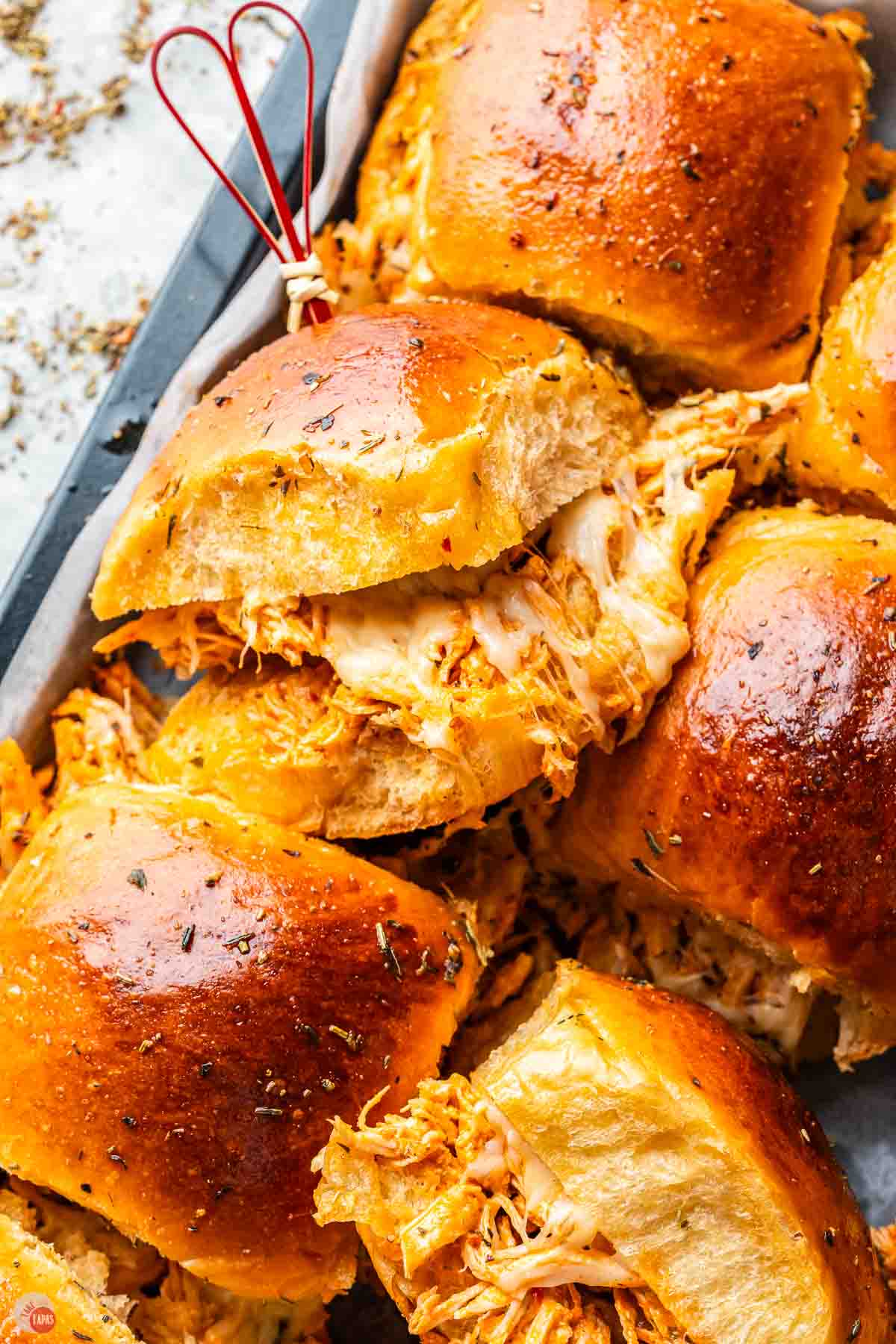 close up of buffalo chicken slider with melted cheese