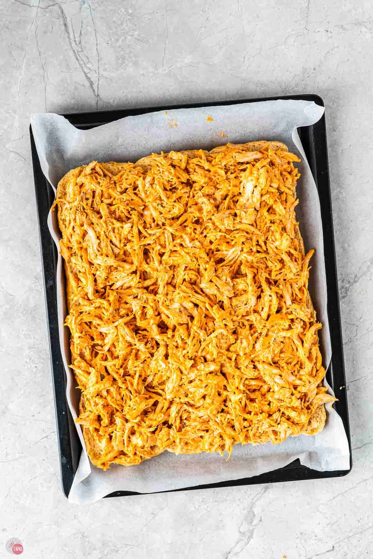 shredded buffalo chicken on cut slider buns