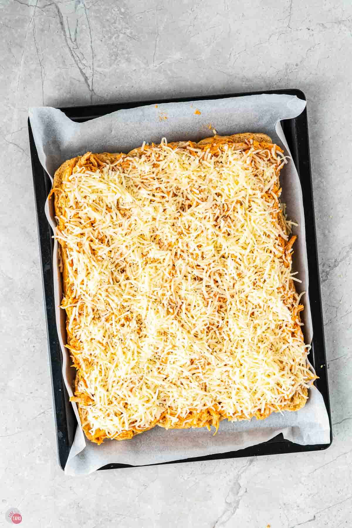 sliders topped with shredded cheese