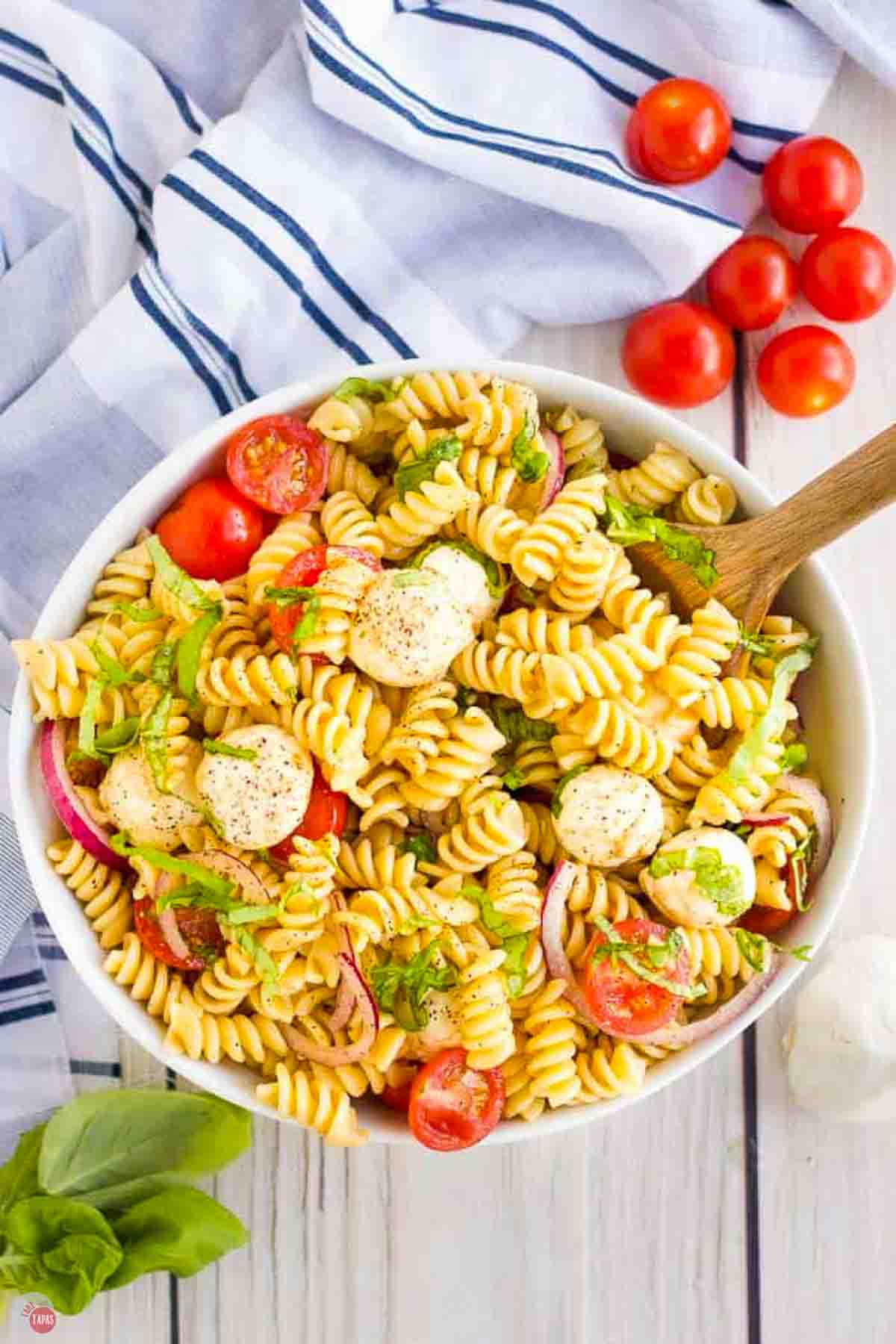 Caprese pasta salad in a white bowl