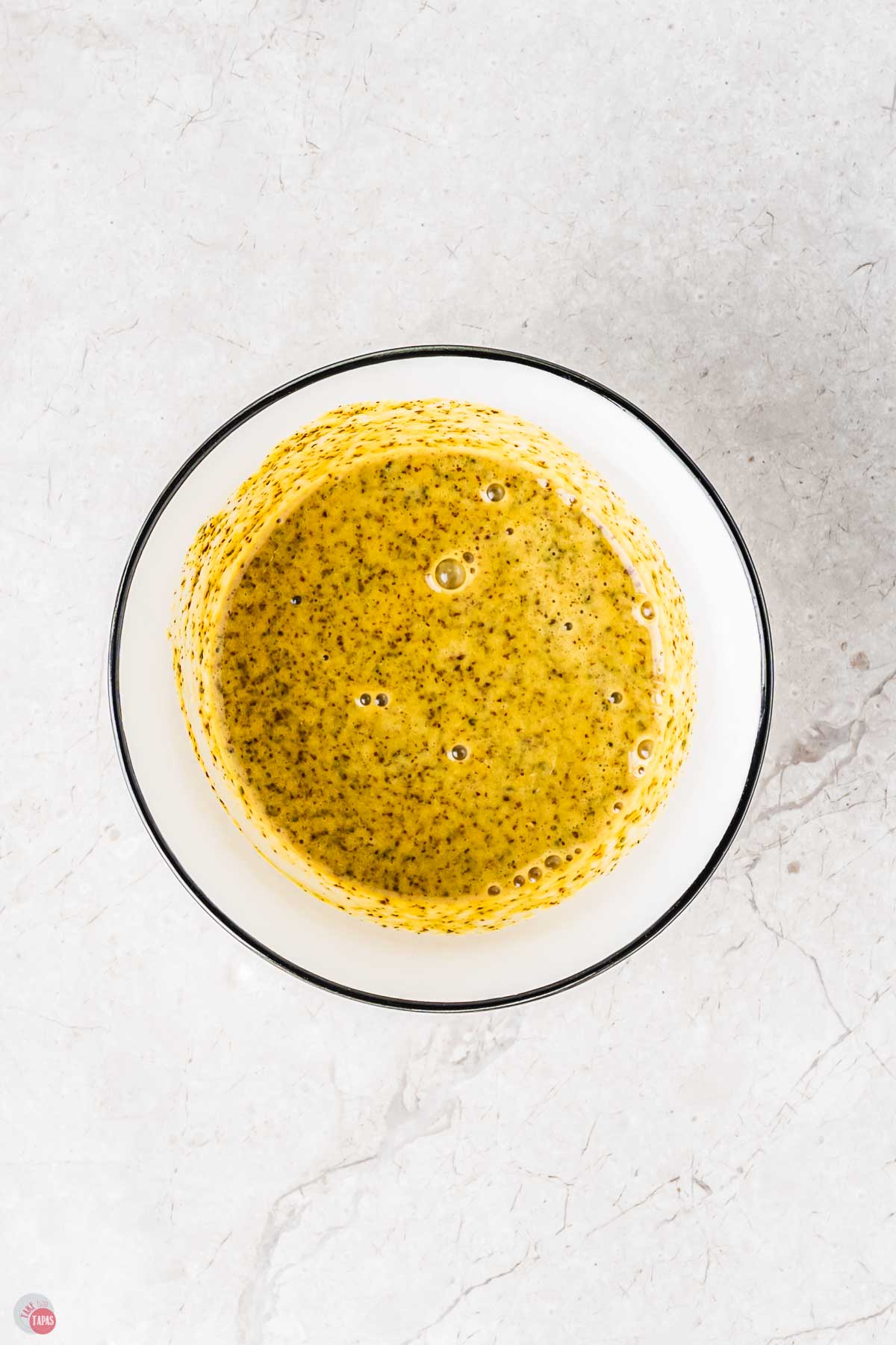 mustard vinaigrette in a white bowl with black trim