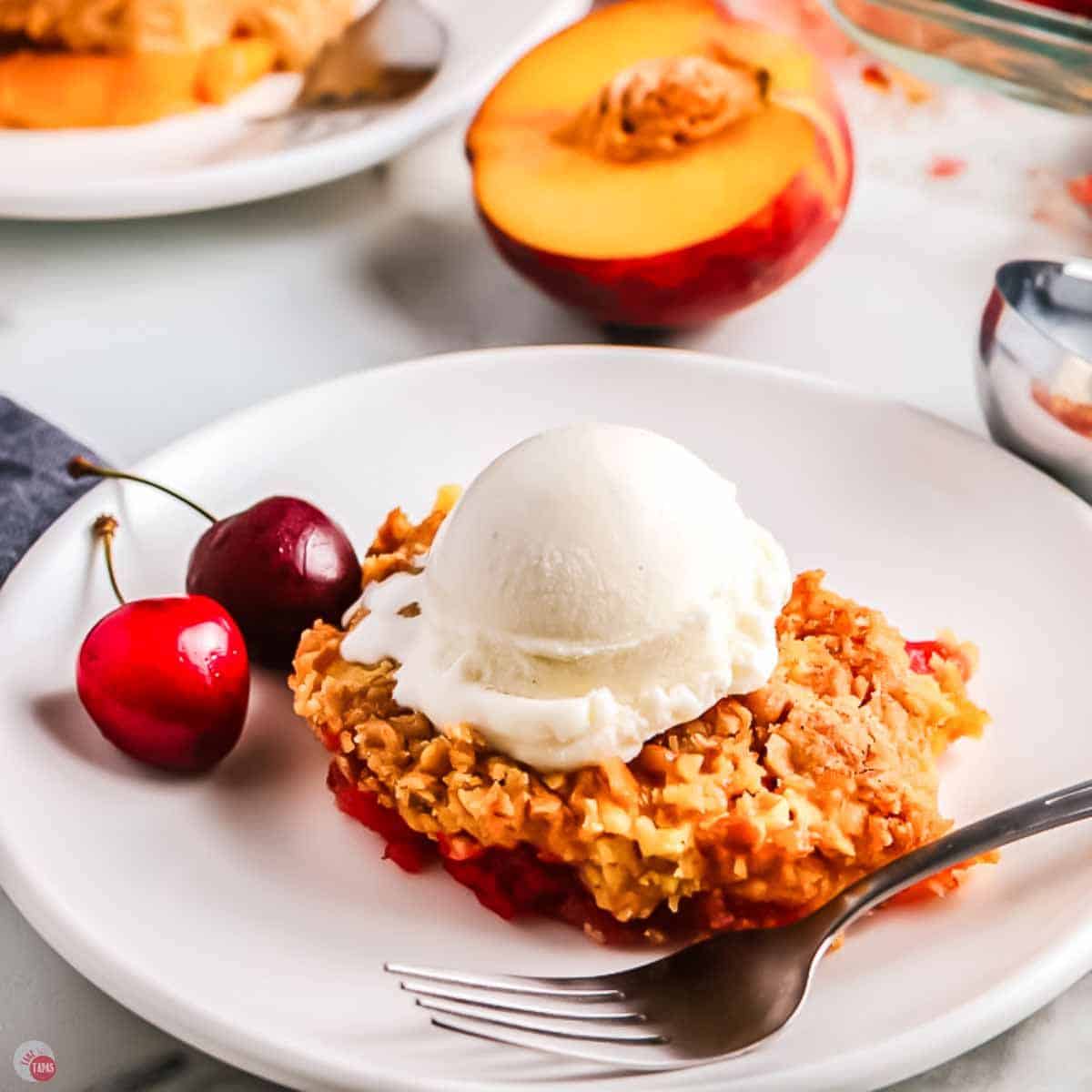 plate with a slice of cherry dump cake and a fork