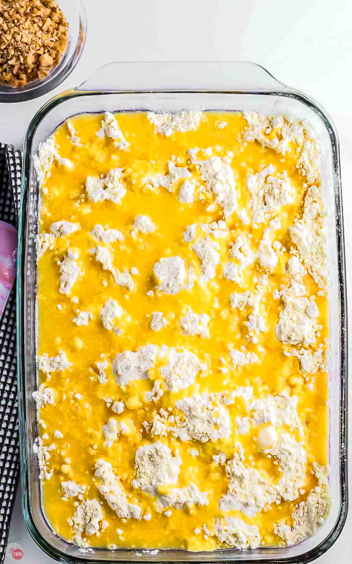unbaked cake mix in a  9x13 dish with melted butter poured on top