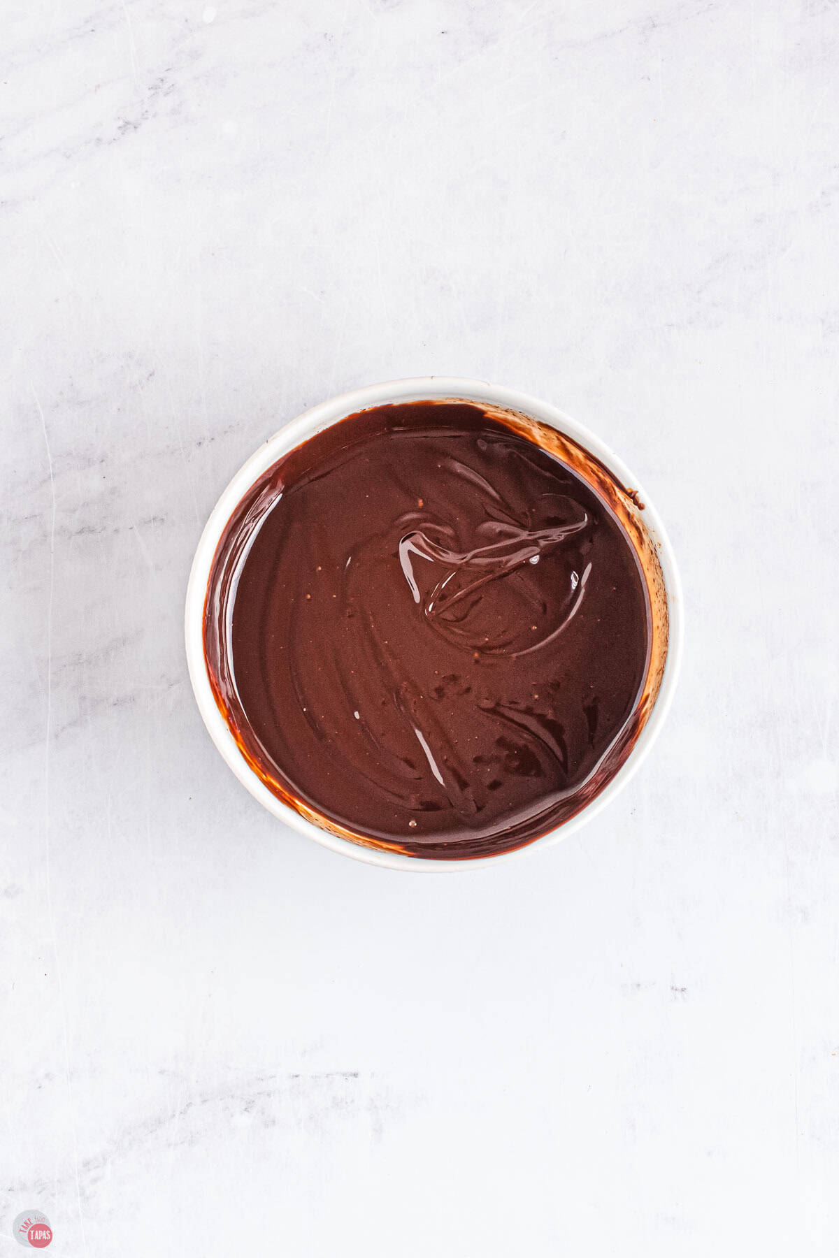 chocolate ganache in a small white bowl