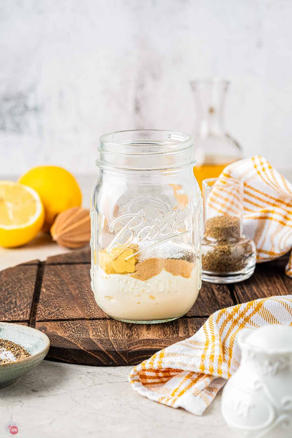 mason jar with mayo and mustard in it