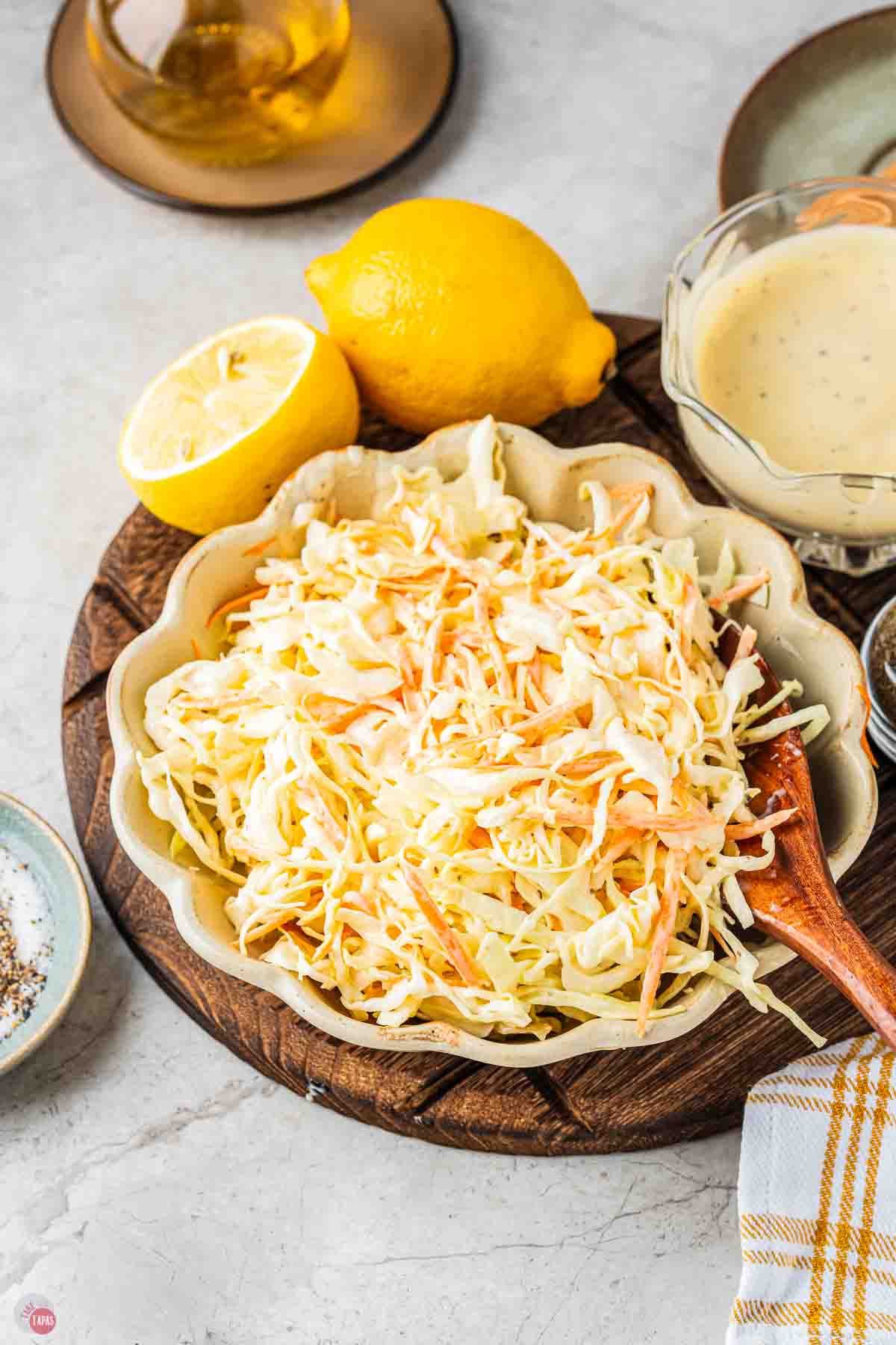 bowl of coleslaw on a wood board