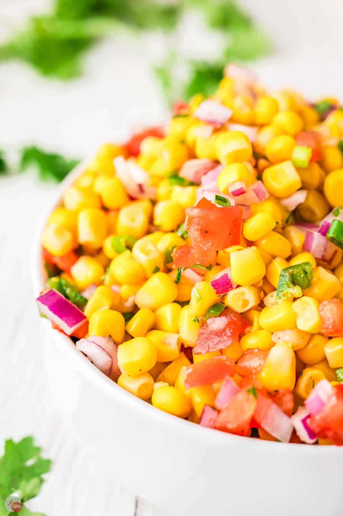 side view of salsa recipe in a white bowl